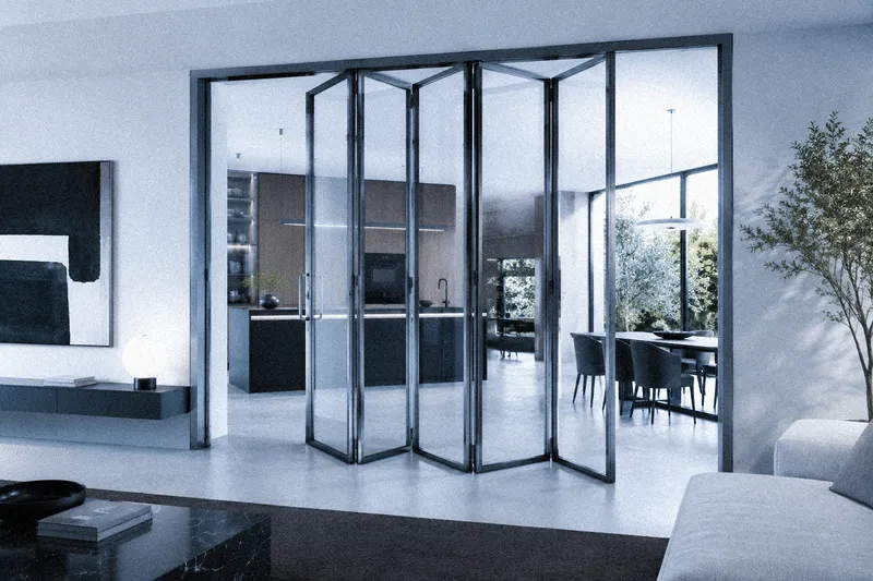 Porta in vetro a soffietto con telaio in alluminio sottile, ideale per separare cucina e living.
